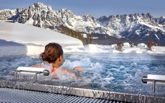 Woman in the whirlpool with a panoramic view of the mountains